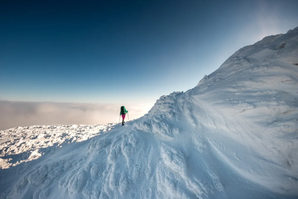 雪の稜線をスノーシューで登る登山者